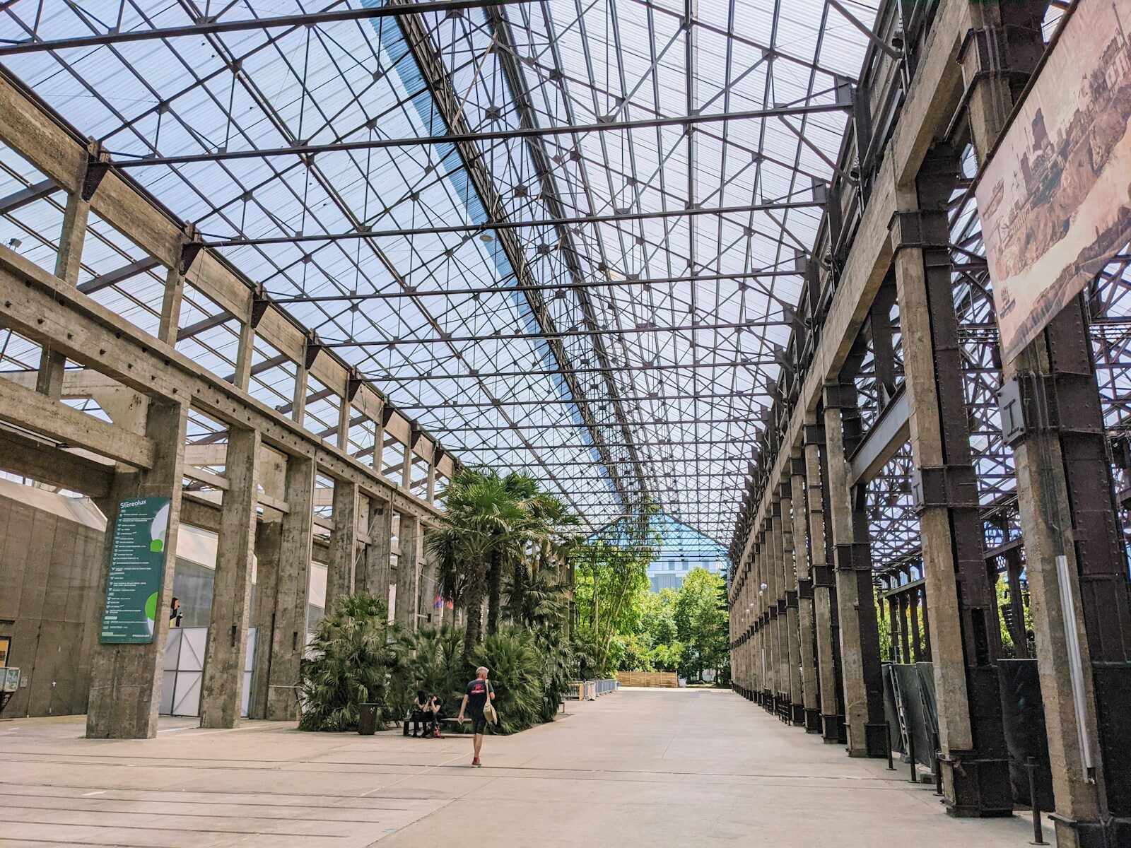 a walkway inside of a building with lots of windows